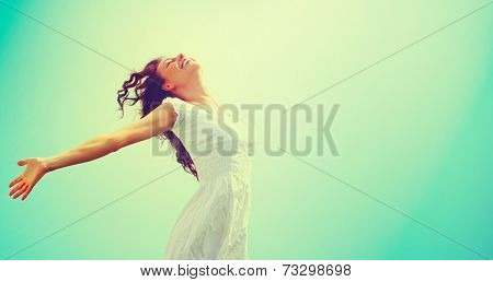 Free Happy Woman Enjoying Nature. Beauty Girl Outdoor. Freedom concept. Beauty Healthy Girl over Sky and Sun. Enjoyment