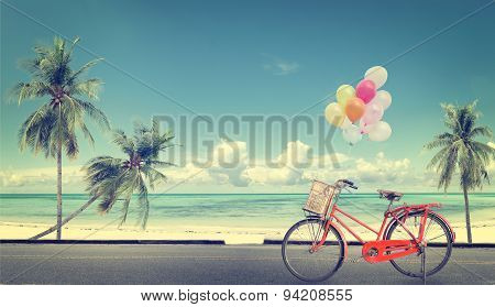 vintage bicycle with balloon on beach