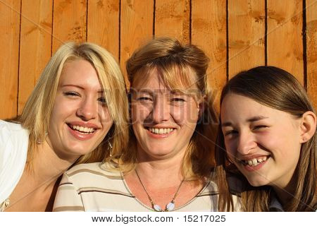 Mother and daughters having fun in a domestic garden situation.