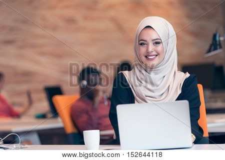 Young Arabic Business Woman Wearing Hijab,working In Her Startup Office. Diversity, Multiracial Conc