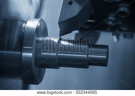 The Cnc Lathe Machine In Metal Working Process Cutting The Metal Shaft Parts With In The Light Blue 