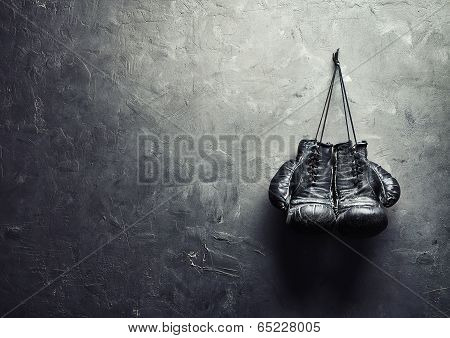 Old Boxing Gloves Hang On Nail On Texture Wall