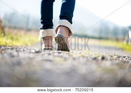 Woman Walking Along A Rural Path