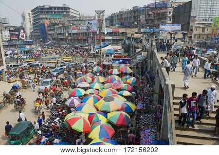 DHAKA, BANGLADESH - FEBRUARY 22, 2014: People do shopping at the Old market in Dhaka, Bangladesh. Dhaka is one of the most overpopulated cities in the world.