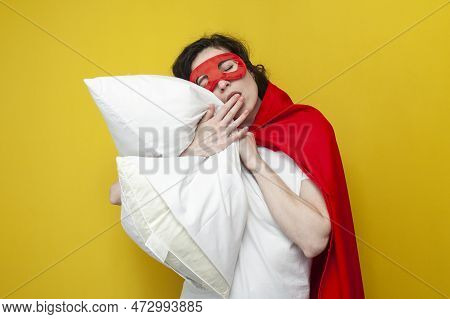 Girl In Superman Costume Sleeps On Soft Pillow And Rests, The Concept Of Healthy Sleep, Woman Superh