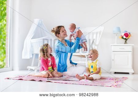 Mother And Kids Playing In Bedroom