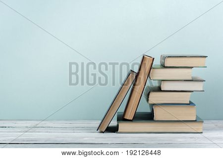 Stack of colorful books. Education background. Back to school. Book, hardback colorful books on wooden table. Education business concept. Copy space for text