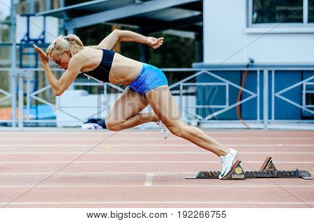 Chelyabinsk Russia - June 4 2017: explosive start female athlete sprinter run 200 meters during UrFO Championship in athletics