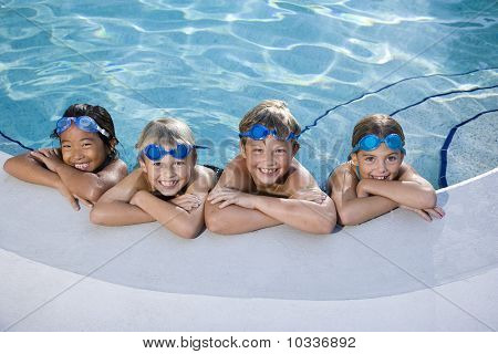 Children Smiling At Edge Of Swimming Pool