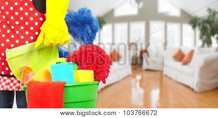 Maid hands with cleaning tools. House cleaning service concept.