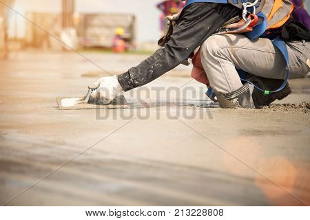 Construction worker Concrete pouring during commercial concreting floors of building in construction site and Civil Engineer