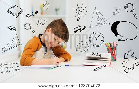 education, childhood, people, homework and school concept - smiling student boy with book writing to notebook at home over mathematical doodles