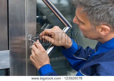 Mature Male Lockpicker Fixing Door Handle At Home