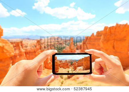 Smartphone taking photo of Bryce Canyon nature. Close up of mobile phone camera screen photographing beautiful american landscape Bryce Canyon, Utah, USA.