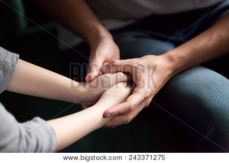 Close Up View Of Couple Holding Hands, Loving Caring Man Supporting Comforting Woman, Giving Psychol