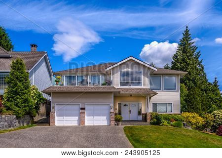 A perfect neighborhood Houses in suburb at Summer in the north America. Fragment of a luxury house with nice window over blue sky.