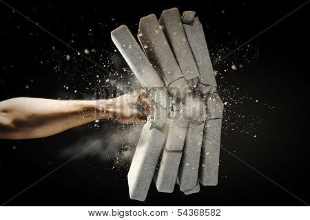 Close up of human hand breaking bricks