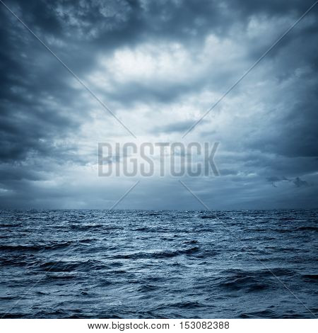 Stormy Sea and Sky. Thundery Clouds and Gray Ocean. Wild Nature Dark Dramatic Background. Toned and Filtered Square Photo with Copy Space.