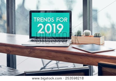 Trends For 2019 Word In Laptop Computer Screen With Tablet On Wood Stood Table In At Window With Blu