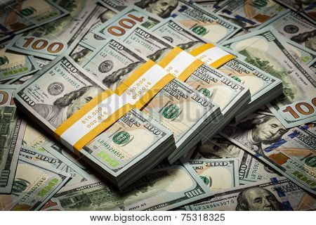 Creative business finance making money concept - background of of new 100 US dollars 2013 edition banknotes (bills) bundles close up