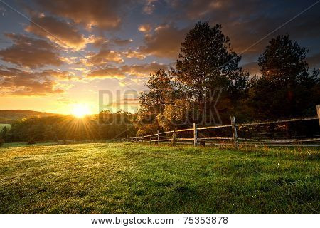 Picturesque landscape fenced ranch at sunrise