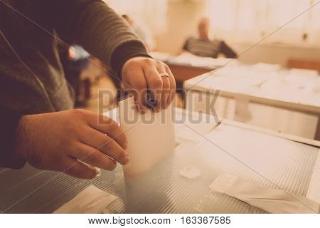 A person casts her ballot during voting for parliamentary elections at a polling station in Bucharest Romania.