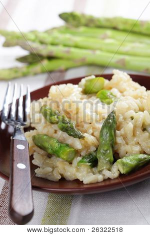 Risotto with asparagus on the brown plate