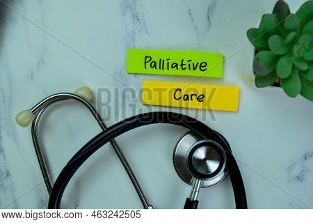 Concept Of Palliative Care Write On Sticky Notes With Stesthoscope Isolated On Wooden Table.