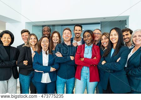 Group Of Multigenerational Business Team Standing In Front Of Camera During Meeting Work - Businessp