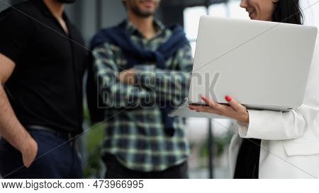 Businessmen In The Lobby Of The Office Presenting A Lapto