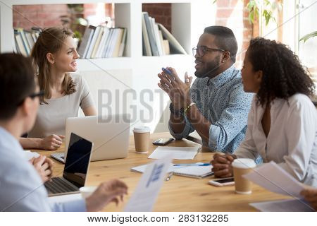 African Male Employee Speaking Sharing Ideas At Diverse Team Meeting