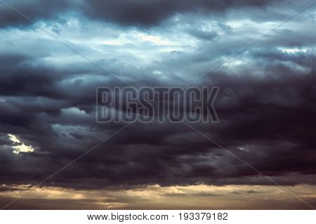 Background of dark clouds before a thunder-storm. Storm clouds in the dark sky. The dark background of bad weather.