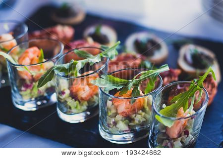 Beautifully decorated catering banquet table with different food snacks and appetizers on corporate christmas birthday party event or wedding celebration