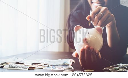 Beautiful young business girl saving money for holiday season saving money concept