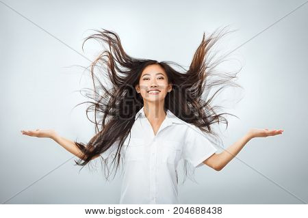 Happy Young Asian Woman With Beautiful Flying Long Hair