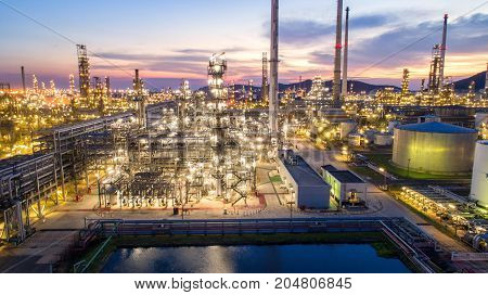 Aerial view Oil refinery.Industrial view at oil refinery plant form industry zone with sunrise and cloudy sky.Oil refinery and Petrochemical plant at dusk Thailand. Oil refinery background sunset.