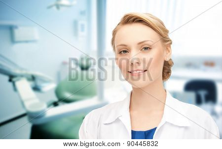 people, medicine, stomatology and healthcare concept - happy young female dentist with tools over medical office background