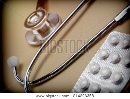 Palliative care, stethoscope and blister pills, conceptual image