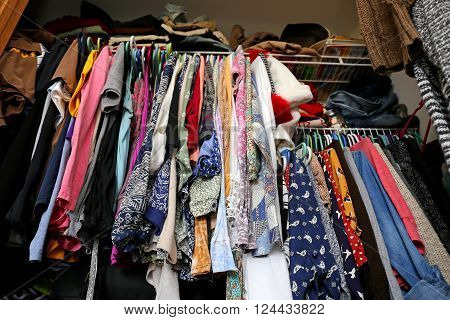 Messy Women's Closet Filled With Colorful Clothes