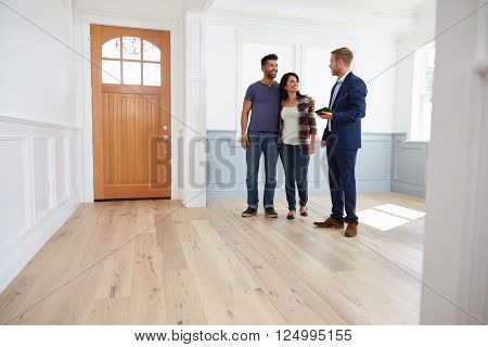 Realtor Showing Hispanic Couple Around New Home