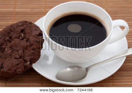 Chocolate Chip Cookie With A Cup Of Black Coffee