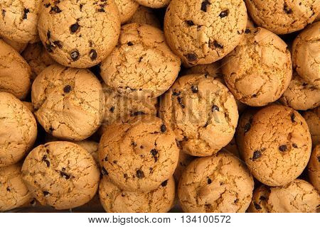 Cookies background. Sweet chocolate chips biscuits and cookies texture background. Oatmeal, chocolated drops and other sweets. Dessert, sweets for tea. Fattening sweets concept