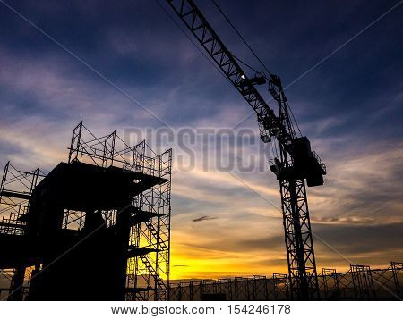 Silhouette Of Scaffolding In The Construction Site Before To Night Time Or Sunset Time. Worker Empty