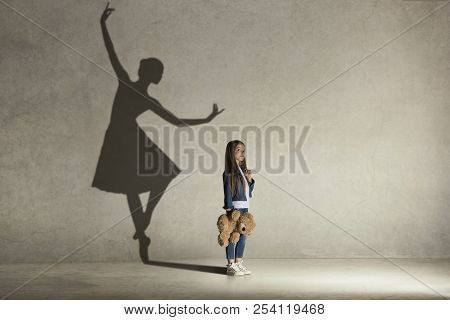 Baby Girl Dreaming About Dancing Ballet. Childhood And Dream Concept. Conceptual Image With Shadow O