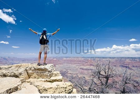 Young man on the top of the Crand Canyon. South rim. Arizona. USA