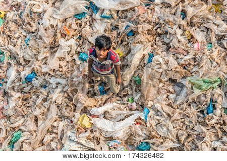 Little Child Stands In The Garbage