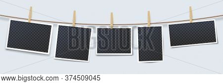 Photos Hanging On Rope Attached With Clothes Pins. Blank Instant Photo Frames With Transparent Place