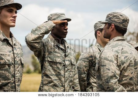 Military trainer giving training to military soldier at boot camp