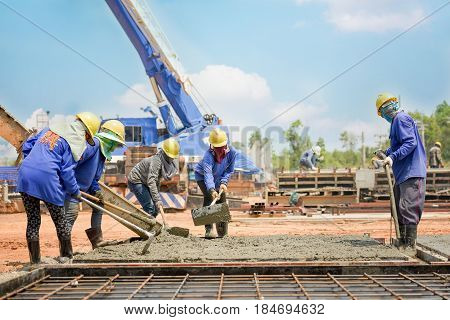 Construction worker Concrete pouring during commercial concreting floors of building in construction site and Civil Engineer or Construction engineer inspec work