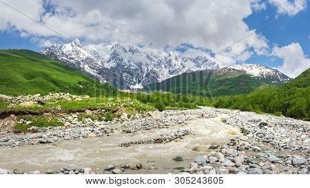 Caucasus Mountains Nature Landscape With Mountain River. Beautiful View On Caucasus Mountains In Geo